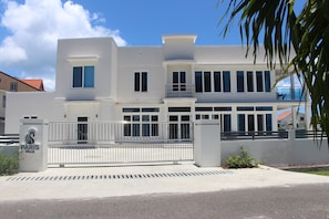 Experience the sleek, contemporary design of Paris Villa, featuring a striking entrance and expansive windows.
