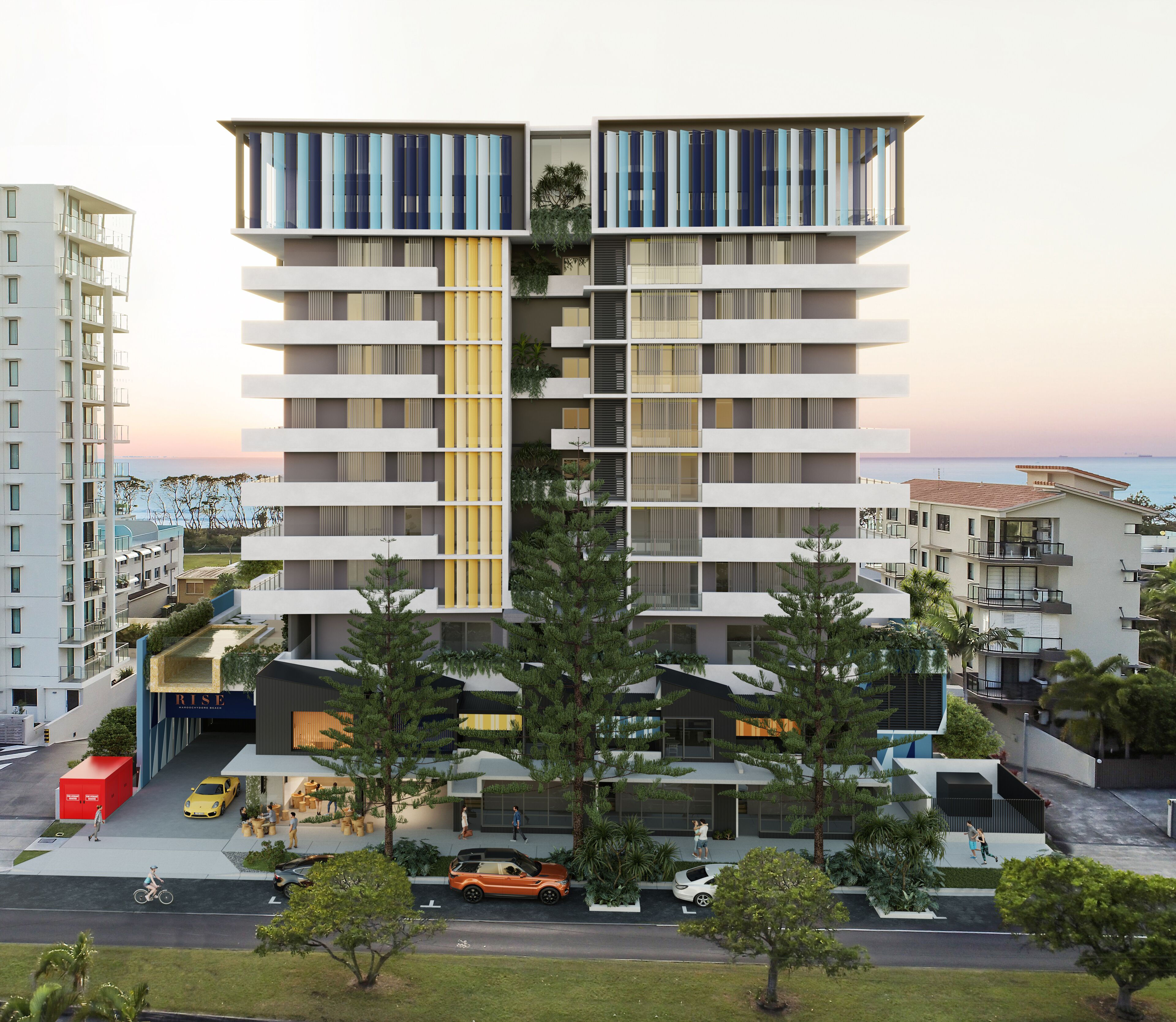 Un edificio residencial de varios pisos con balcones, un atrio central y vista al mar.