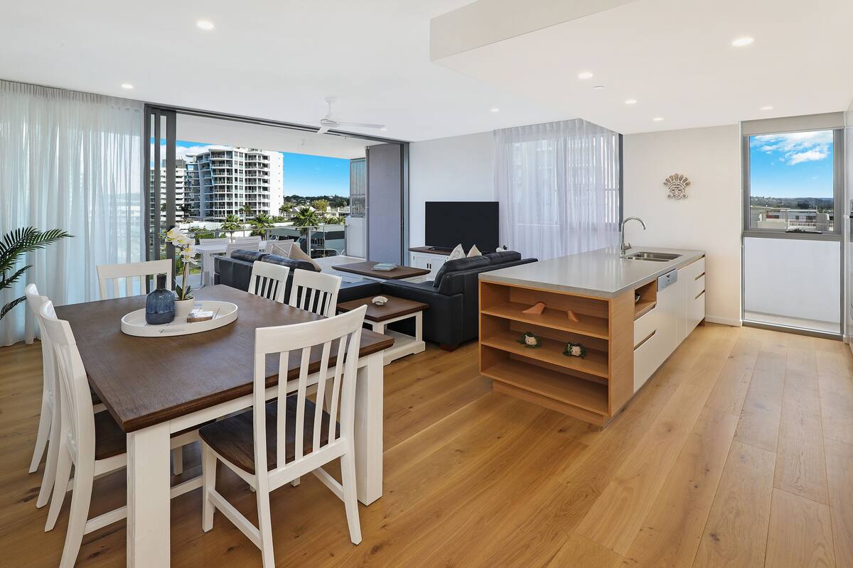Un apartamento moderno con comedor, sala de estar y cocina.