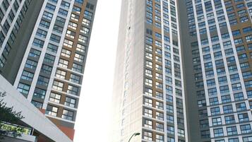 A high-rise building with multiple floors, large windows, and a modern architectural design.