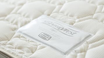A mattress with a label indicating it is from Simmons, a brand known for mattresses.