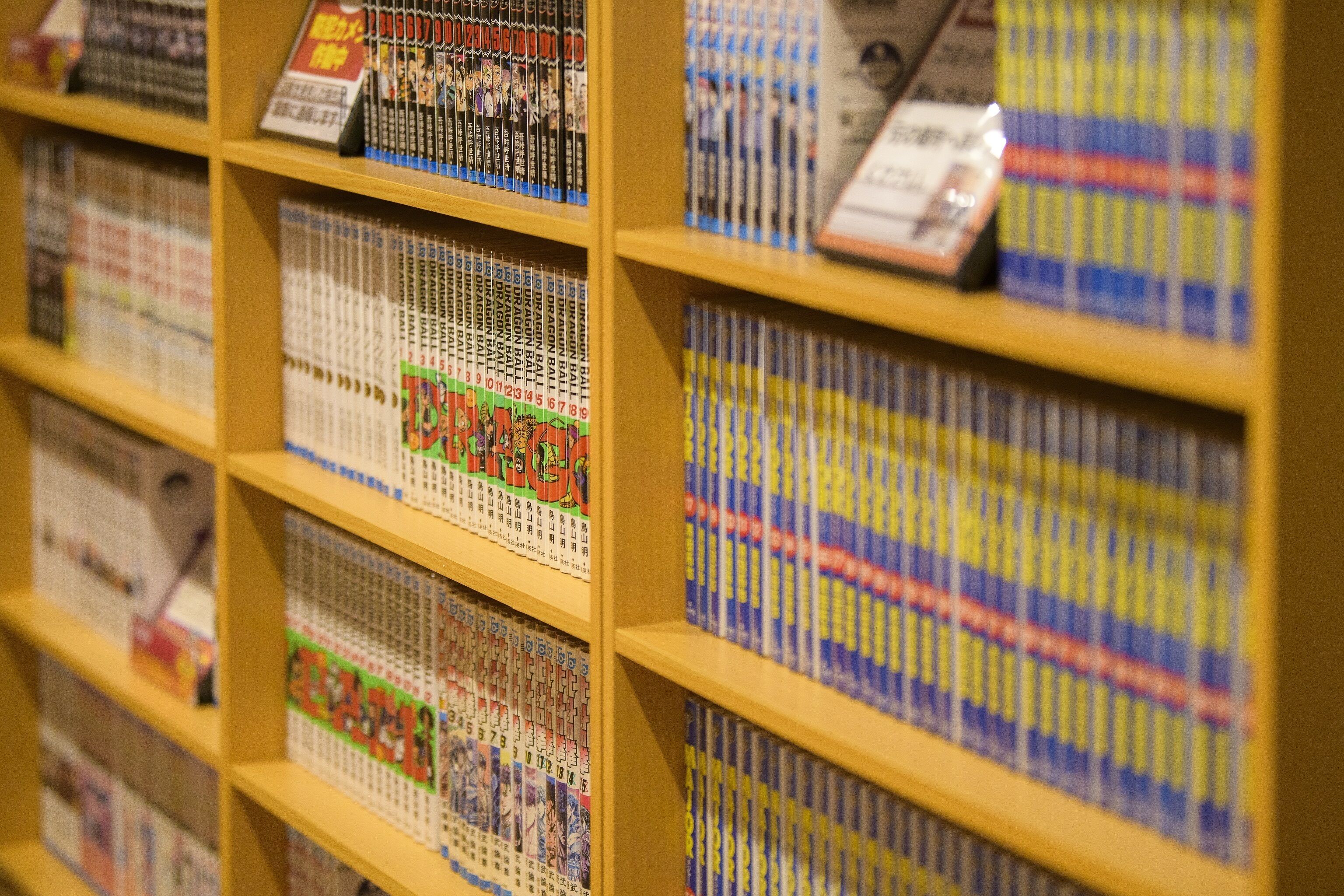 A bookshelf filled with manga volumes.
