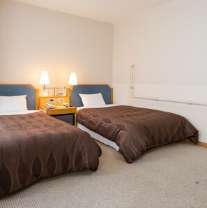 Two single beds with brown patterned duvets, a nightstand, telephone, and lamp.