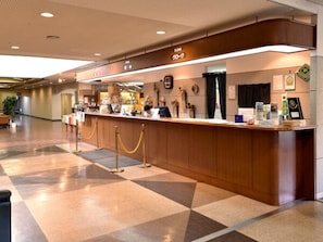 Welcome to the hotel reception, where guests can check in and enjoy a warm, inviting atmosphere.