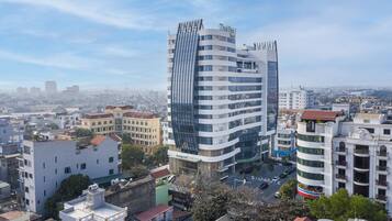 Hotel features a distinctive curved facade and multiple balconies.