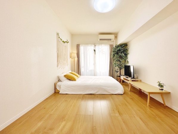 Relax in this serene bedroom with a large bed and a TV for entertainment.