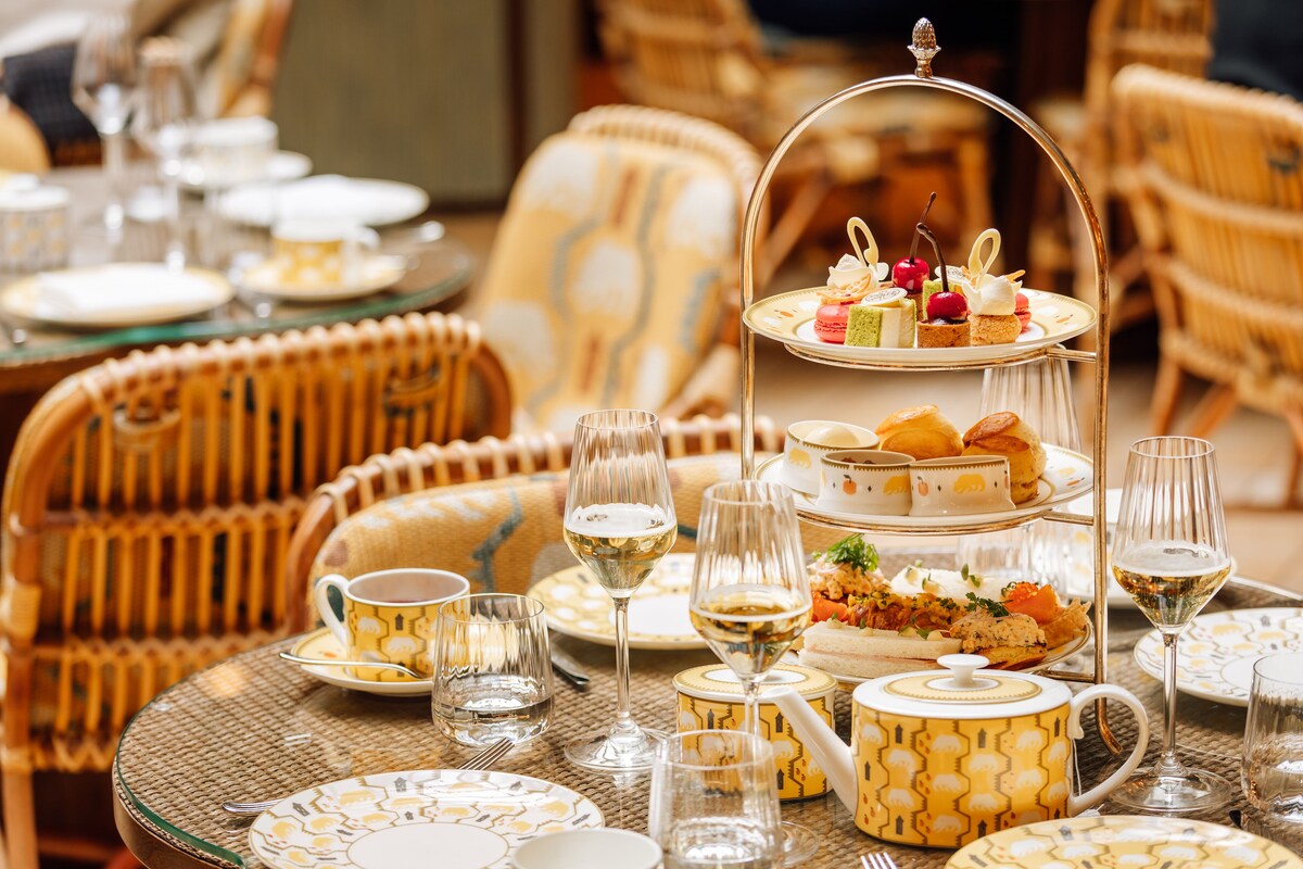 Tiered plate of pastries and snacks with tea