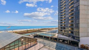 A high-rise building with a view of the beach and ocean.
