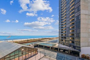 A high-rise building with a view of the beach and ocean. - XPLORIE ACTIVITIES & LINENS INCLUDED*!  2BR/2BA Capri condo with ocean & bay views! (Ocean City)