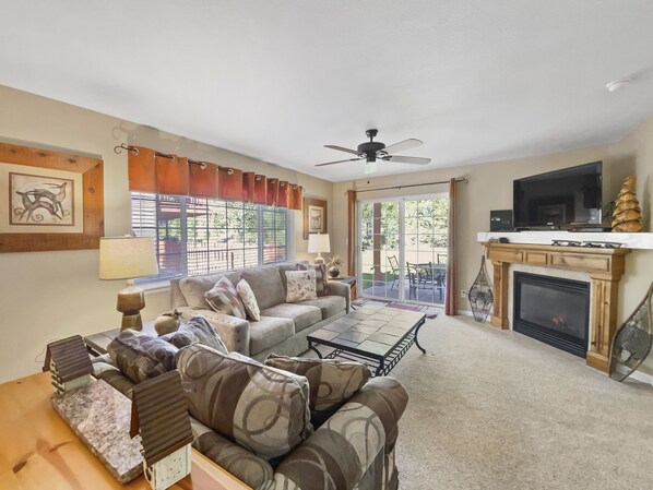 A living room with a sofa, coffee table, and fireplace. - Swans Nest Villa 1304 2 Bedroom Condo by RedAwning (Breckenridge)