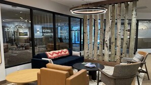 A modern lounge area with a sofa, armchairs, a coffee table, and a patterned rug. - Steps from Riverfront Gondola, Modern Cozy Condo, Free Underground Parking (Avon)