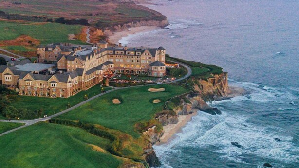 A large, multi-story building with a golf course and ocean views. - Experience the perfection of Half Moon Bay Oasis By Pillar Point Beach! (El granada)