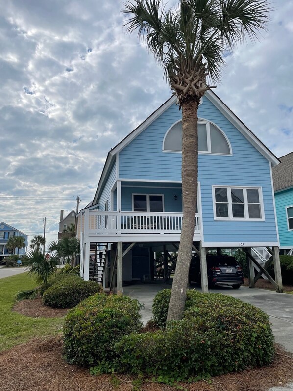 A two-story house with a balcony and a covered porch. - Steps to the beach, quiet area of beach. (Surfside Beach)