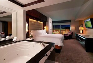 Relax in a spacious room with a large bed, bathtub, and city views.