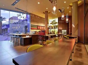 Enjoy meals in this stylish dining area with a long table and comfortable seating.