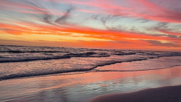 A beach with waves and a sunset sky. - Condo# 107  Two minutes walk to the Beach! (Sarasota)