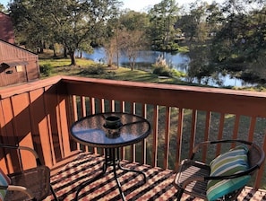 Enjoy a serene view from this deck overlooking the water, where you can sit and relax with a friend.