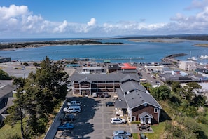A coastal hotel with a parking lot, a marina, and a view of the sea.