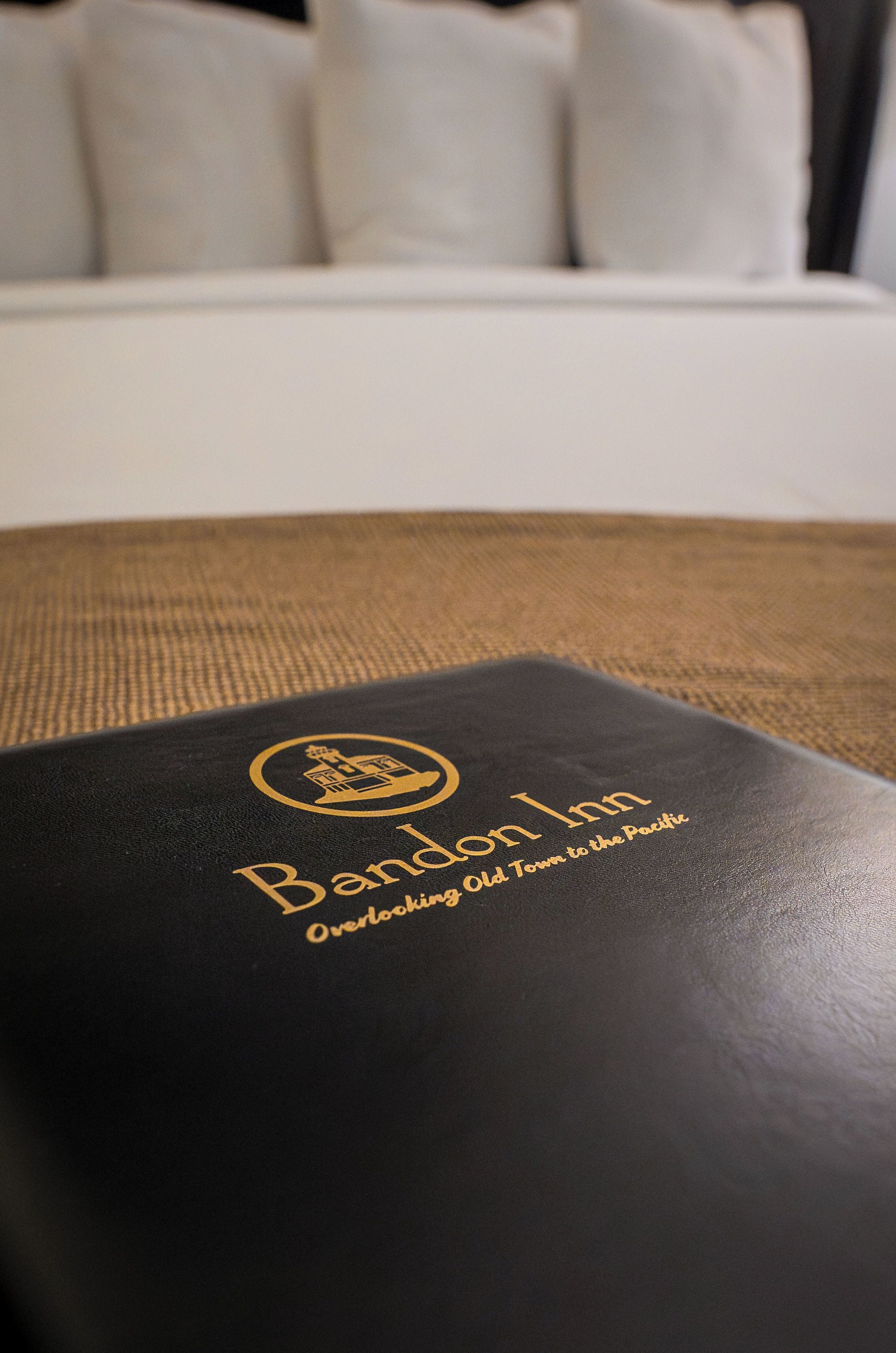 A black booklet with the text "Band Inn Overlock Town to the Pacific" on a textured surface.