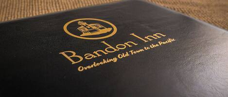 A black booklet with the text "Band Inn Overlock Town to the Pacific" on a textured surface.