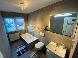 Bathtub, hair dryer, towels, soap