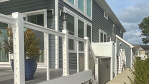 A house with a covered porch, a stone pathway, and a blue planter. - Peaceful Waterfront Family Retreat in North Ocean City (Ocean City)