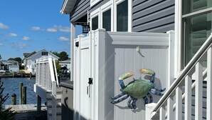 A waterfront property with a covered deck and a crab decoration. - Peaceful Waterfront Family Retreat in North Ocean City (Ocean City)
