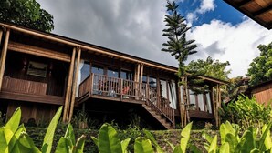 A two-story wooden building with a balcony and stairs leading to the upper level.