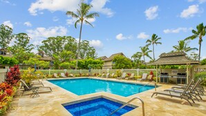 A swimming pool with a hot tub, surrounded by lounge chairs and palm trees. - Bright and Beautiful Princeville Studio, Private Lanai, Pool (209B) (Princeville)