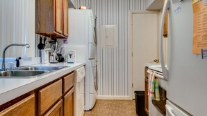 A compact kitchen with a sink, stove, and refrigerator. - This newly built, modern, 2 bedroom, 1 bathroom rental condo is located on the south end of Chautauqua Institution (Chautauqua)