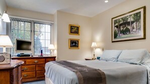 A bedroom with a bed, dresser, TV, and framed pictures on the wall. - This newly built, modern, 2 bedroom, 1 bathroom rental condo is located on the south end of Chautauqua Institution (Chautauqua)