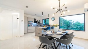 A modern kitchen with a dining area.