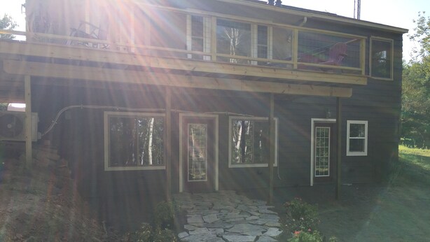 A two-story house with a stone pathway leading to the front door. - Stonehaven Cottages - "The Birchview Suite Duplex - Lower Level" (Rice Lake)