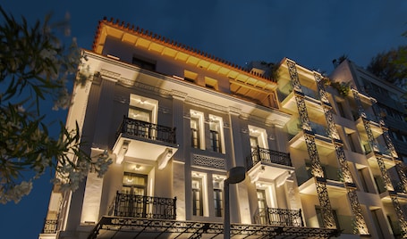 A multi-story building with balconies and a decorative facade.