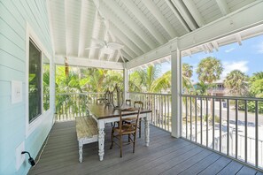Outdoor dining - Charming cottage with heated pool, tropical landscaping in prime location. (Anna Maria)
