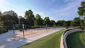 A park with a paved walkway, benches, and a grassy area. - Historic 155 y/o 3-bedroom KC house with hot tub. (Kansas City)