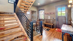 A spiral staircase with wooden steps and metal railings, leading to an upper floor.