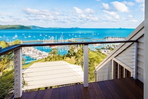 A balcony with a view of a marina and a pool. - Airlie Beach Seaviews (Airlie Beach)