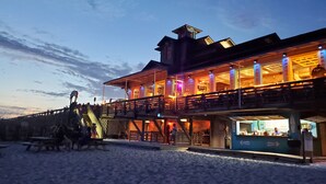 A beachfront building with multiple balconies and a bar area. - Pet-Friendly Maravilla Condo–Beach Ramp, Pools, Free Beach Setup, 1BDR + Bunks (Miramar Beach)