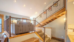 A staircase with wooden steps and metal railings, leading to an upper level. - 300 off for Christmas 12/23-26 Ski in/Walk Out. Private Hottub Sleeps 8 2Br+Loft (Park City)