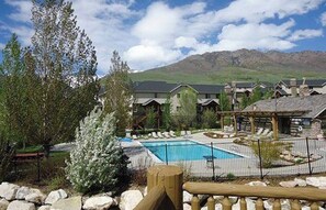 A resort with a swimming pool, guest cabins, and a mountain backdrop. - Luxury Moose Hollow, Powder mountain,  3 bedroom/hot tub Condo in Eden Utah. (Eden)