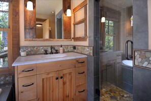 Bathtub, hair dryer, towels, shampoo