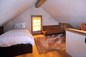 A bedroom with a bed, a chair, a desk, a window, and a wooden ceiling. - Elk Ave Luxury, Gorgeous 3+ BR Custom Home in CB (Crested Butte)