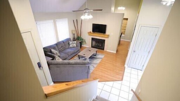 A modern living room with a grey sofa, a fireplace, and a television. - Culberhouse Cottage - Executive/Vacation Rental (Jonesboro)