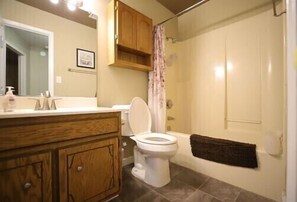 Combined shower/bathtub, towels, soap, toilet paper