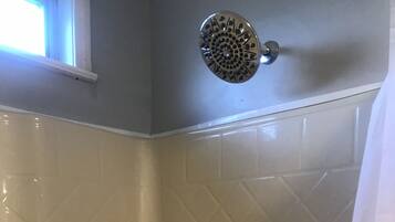 Combined shower/bathtub, hair dryer, towels, toilet paper