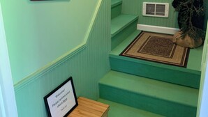 A staircase with teal walls, a welcome sign, a framed sign, and a bear decoration. - Relax at 3100 feet and enjoy the peace and tranquility (Free Union)