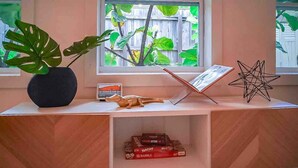A wooden desk with a potted plant, a star-shaped object, and a book.