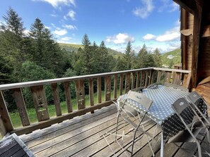 Enjoy al fresco dining on this deck with a forest and mountain view.