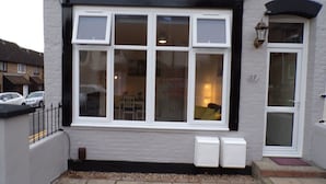 A residential building with a large window, a door with a number, and two electrical boxes. - Inviting 3-bed Apartment in Southend-on-sea (Southend-on-Sea)